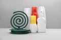 Set of different insect repellents on grey background