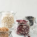 Set of different legumes in glass jars on a wooden table. A source of protein for vegetarians Healthy eating concept