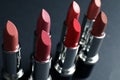 Set of different lipsticks on grey background. Cosmetic product Royalty Free Stock Photo