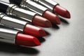 Set of different lipsticks on grey background Royalty Free Stock Photo