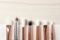 Set of different makeup brushes drying after cleaning on white wooden table, flat lay. Space for text Royalty Free Stock Photo