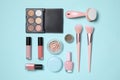 Set of different makeup products on turquoise background, flat lay Royalty Free Stock Photo