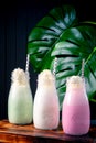 Set of different milkshakes with strawberries, mint and vanilla in glasses