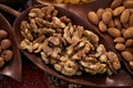 Set of different nuts, almonds, walnuts, hazelnuts in brown wooden bowl Royalty Free Stock Photo