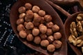 Set of different nuts, almonds, walnuts, hazelnuts in brown wooden bowl Royalty Free Stock Photo