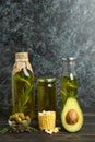 Set of different oils on rustic wooden table