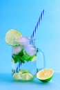 Set of different pieces fresh fruits in glass on a blue background. Summer fresh coctail. Royalty Free Stock Photo