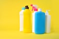 Set of different  plastic bottles from household chemistry on a yellow background Royalty Free Stock Photo