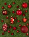 A set of different red Christmas toys on a green background of Christmas tree needles. Red ball. Decor and decorations Royalty Free Stock Photo