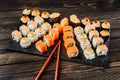 Set of different rolls and sushi on a dish with chopsticks