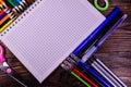 Set of different school stationeries. Notepad, scissors, pensils, on wooden desk. Back to school. Top view Royalty Free Stock Photo