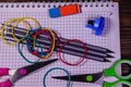 Set of different school stationeries. Notepad, scissors, pensils, on wooden desk. Back to school. Top view Royalty Free Stock Photo