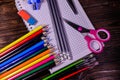 Set of different school stationeries. Notepad, scissors, pensils, on wooden desk. Back to school. Top view Royalty Free Stock Photo