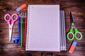 Set of different school stationeries. Notepad, scissors, pensils, on wooden desk. Back to school. Top view Royalty Free Stock Photo