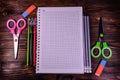 Set of different school stationeries. Notepad, scissors, pensils, on wooden desk. Back to school. Top view Royalty Free Stock Photo
