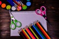 Set of different school stationeries. Notepad, scissors, pensils, paints, paintbrushes on wooden desk. Back to school. Top view Royalty Free Stock Photo