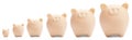 Set with different sized beige piggy banks Royalty Free Stock Photo