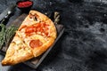 Set of Different slices of pizza. Black background. Top view. Copy space