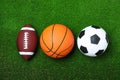 Set of different sport balls on green grass, flat lay Royalty Free Stock Photo