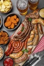 Set of different tasty snacks and beer on dark grey table, flat lay Royalty Free Stock Photo