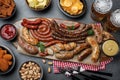 Set of different tasty snacks and beer on dark grey table, flat lay Royalty Free Stock Photo