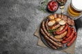 Set of different tasty snacks and beer on dark grey table, flat lay. Space for text Royalty Free Stock Photo