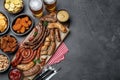 Set of different tasty snacks and beer on dark grey table, flat lay. Space for text Royalty Free Stock Photo