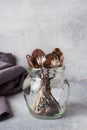 A set of different teaspoons in a glass jar. Gray background with copy space Royalty Free Stock Photo