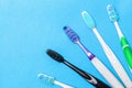 Set of different toothbrushes on blue background