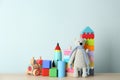 Set of different toys on wooden table. Space for text