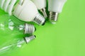 A set of different types of LED lamps isolated on a green background. Energy-saving lamps. Royalty Free Stock Photo