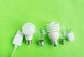 A set of different types of LED lamps isolated on a green background. Energy-saving lamps Royalty Free Stock Photo