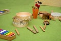 Set of different wooden percussion instruments on green carpet