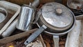 A set of dirty pots teapot and utensils in an outdoor mud kitchen