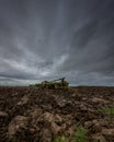 A set of Disc Harrows in a ploughed field under a very heavy sky. Royalty Free Stock Photo