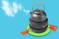 A set of dishes for camping or hiking, the concept of outdoor activities, the kettle releases steam