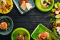 A set of dishes of meat and fresh vegetables and fish on a wooden table. Royalty Free Stock Photo