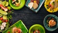 A set of dishes of meat and fresh vegetables and fish on a wooden table. Royalty Free Stock Photo