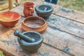 Set of dishes a pair of plates, a beer mug and a mortar on a wooden table