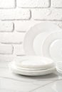 Set of dishes on table against brick wall background Royalty Free Stock Photo