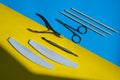 Set of disinfected manicure or pedicure tools on yellow and blue background Cuticle pushers and scissors for safe Royalty Free Stock Photo
