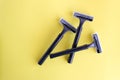 Set of disposable black razors on a yellow background Royalty Free Stock Photo
