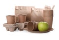 Set of disposable eco friendly dishware and apple on white Royalty Free Stock Photo