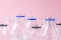 Set of diverse used empty water plastic bottles without caps on pastel pink background. Concept of recycle plastic pakaging, reuse Royalty Free Stock Photo