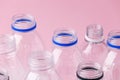 Set of diverse used empty water plastic bottles without caps on pastel pink background. Concept of recycle plastic pakaging, reuse Royalty Free Stock Photo