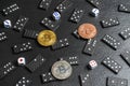 A set of domino bones,dices and bitcoins on black stone background