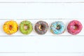 Set of donuts on white wooden background Royalty Free Stock Photo