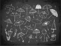 Set of doodle sketch umbrellas on blackboard background Royalty Free Stock Photo