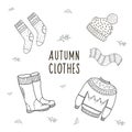 Set of drawings of autumn clothes. Illustration by hand in the style of doodle. Linear illustartion Royalty Free Stock Photo