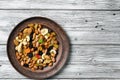 Set of dried fruits and nuts on a clay plate top view Royalty Free Stock Photo